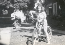 The first picture is me on my bike (with my little sister in the background).  Behind me is the Nitzsche's house. Our house is to the left and not in the frame but was identical.